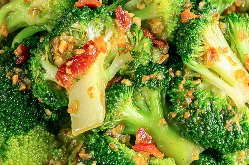 Asian Broccoli with Garlic Sauce and Crispy Bacon on a white plate