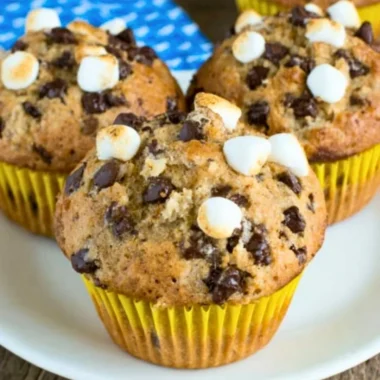 Freshly baked banana s'mores muffins with chocolate and marshmallows
