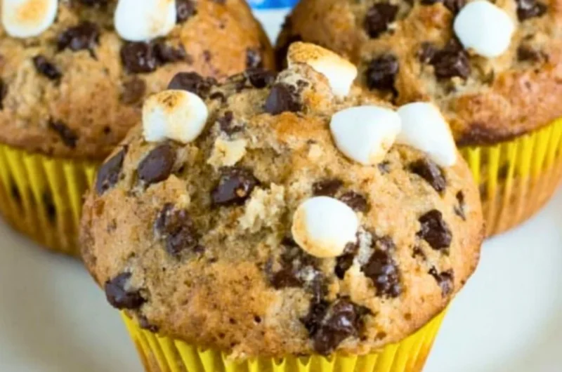 Freshly baked banana s'mores muffins with chocolate and marshmallows