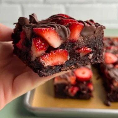 Delicious chocolate covered strawberry brownies with fresh strawberries on top