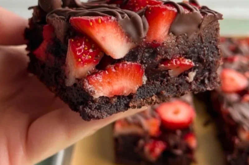 Delicious chocolate covered strawberry brownies with fresh strawberries on top