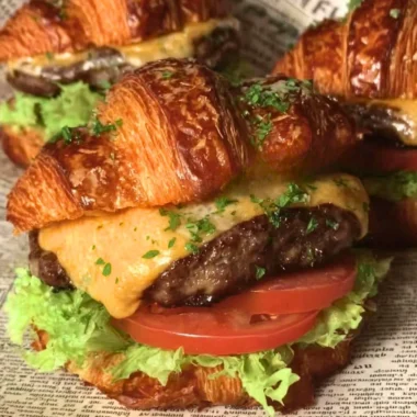 Delicious Croissant Smash Burgers served with fresh toppings