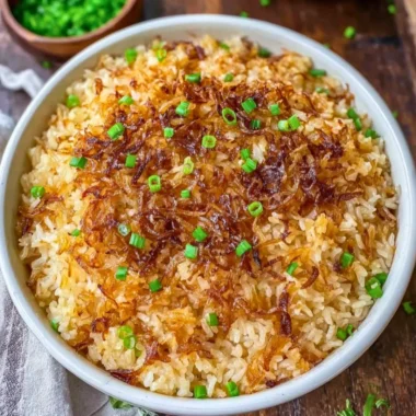 Delicious serving of French Onion Butter Rice garnished with herbs.