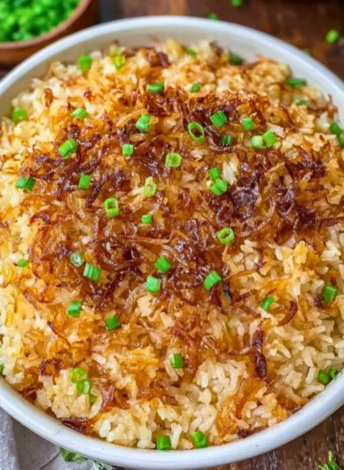 Delicious serving of French Onion Butter Rice garnished with herbs.