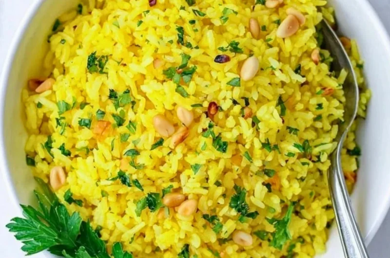 Bowl of Mediterranean yellow rice garnished with herbs
