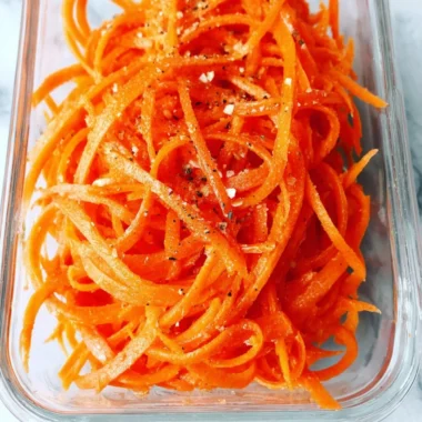 Fresh raw carrot salad with colorful vegetables and dressing