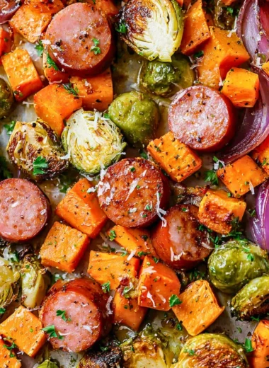 Sheet-pan sausage with fall vegetables ready to serve on a plate.
