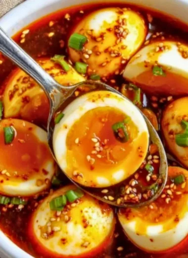 Spicy Gochujang Eggs served on a plate with fresh herbs and chili flakes