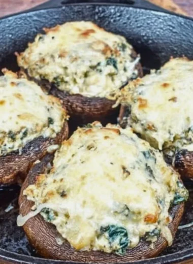 Spinach and ricotta stuffed portobello mushrooms arranged on a plate