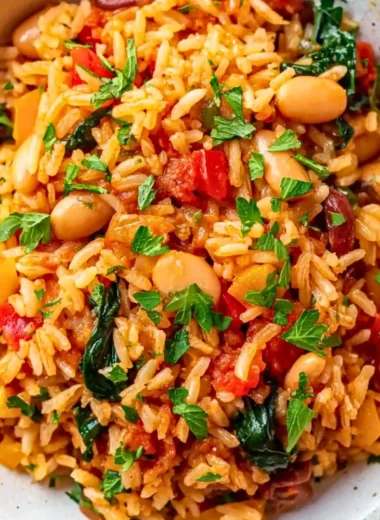 Delicious Mediterranean Rice and Beans served in a bowl with fresh herbs.