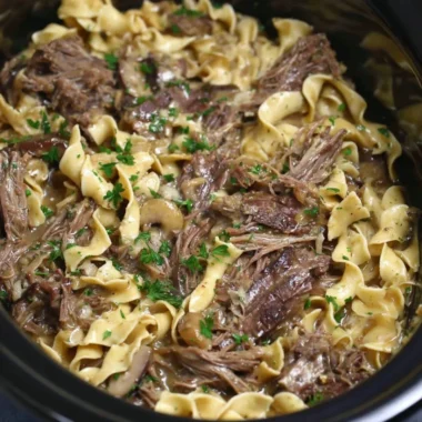 Crock pot beef and noodles dish served in a bowl for a family dinner