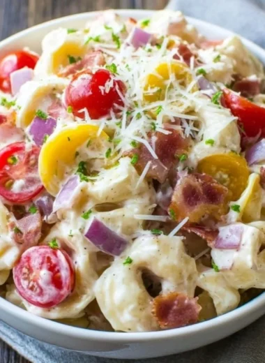 Delicious Grinder Tortellini Salad featuring fresh pasta, veggies, and herbs.
