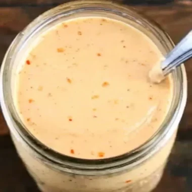 Bottle of Boom Sauce showcasing its bold and flavorful condiment for meals.