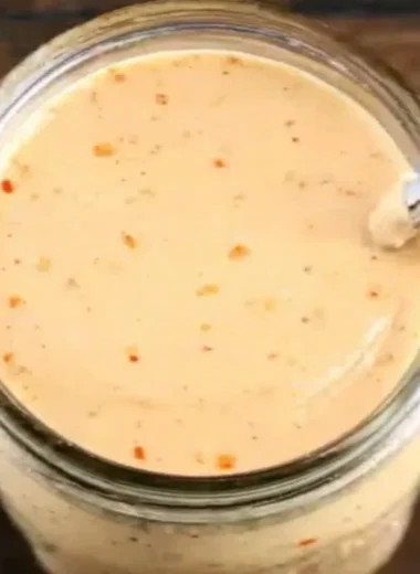 Bottle of Boom Sauce showcasing its bold and flavorful condiment for meals.