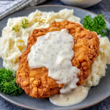 Deliciously crispy Chicken Fried Chicken served with gravy and sides