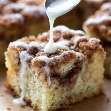 Deliciously moist coffee cake sliced and ready to serve with a coffee cup.