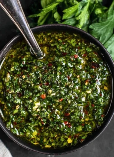 Fresh chimichurri sauce in a small bowl with herbs and garlic