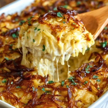 French Onion Chicken Orzo Casserole topped with melted cheese and onions