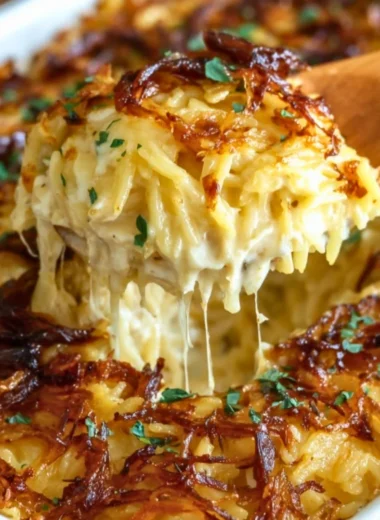 French Onion Chicken Orzo Casserole topped with melted cheese and onions