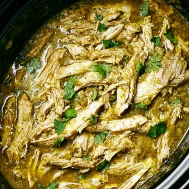 Delicious Green Sauce Slow Cooker Chicken served in a bowl with fresh herbs