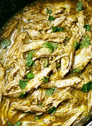 Delicious Green Sauce Slow Cooker Chicken served in a bowl with fresh herbs