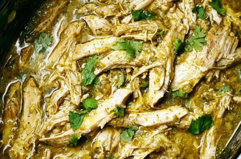 Delicious Green Sauce Slow Cooker Chicken served in a bowl with fresh herbs