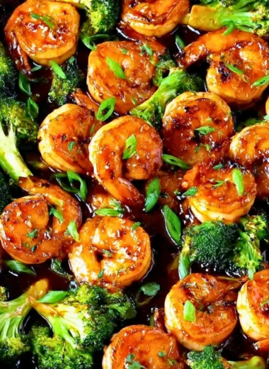 Close-up of Honey Garlic Butter Shrimp on a plate with garnishes.