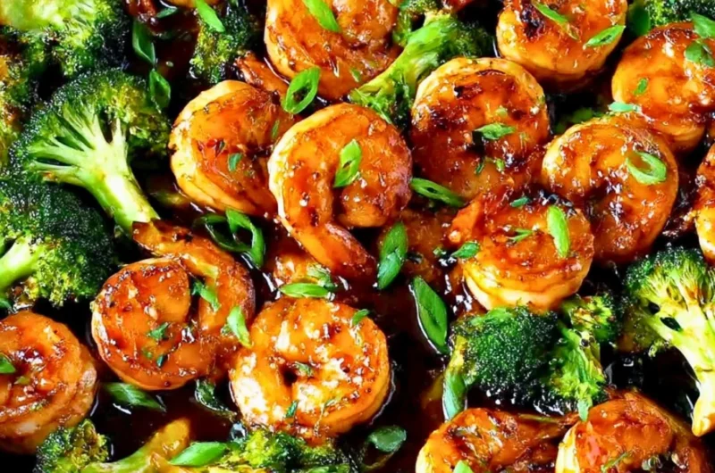 Close-up of Honey Garlic Butter Shrimp on a plate with garnishes.