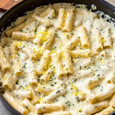 Creamy Lemon Garlic Sauce drizzled over pasta and garnished with parsley