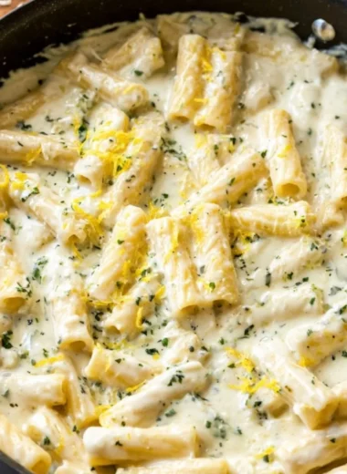 Creamy Lemon Garlic Sauce drizzled over pasta and garnished with parsley
