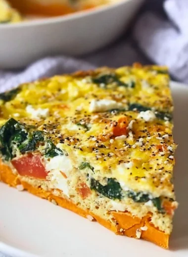 Spinach and goat cheese quiche with sweet potato crust served on a plate