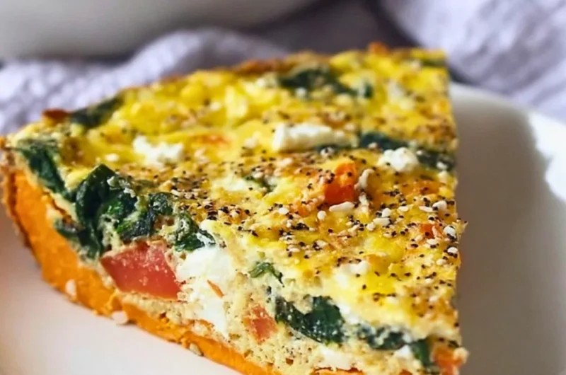Spinach and goat cheese quiche with sweet potato crust served on a plate
