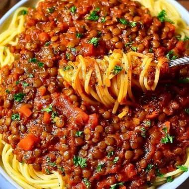 Bowl of Vegan Bolognese with fresh herbs and pasta