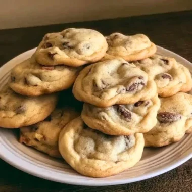 Freshly baked chocolate chip cookies cooling on a wire rack