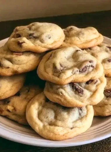 Freshly baked chocolate chip cookies cooling on a wire rack