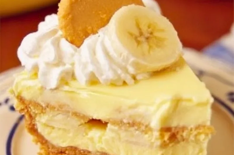 Slice of banana pudding cheesecake with banana slices on top