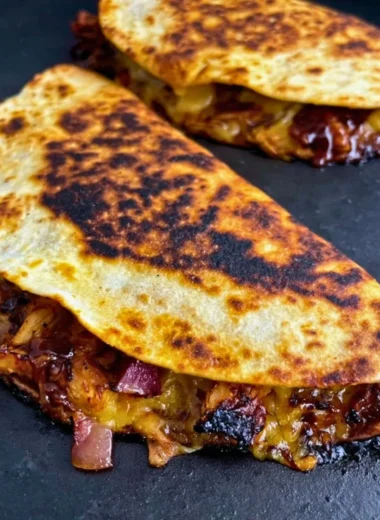 Deliciously grilled Blackstone Hot Honey BBQ Chicken Quesadillas filled with melted cheese