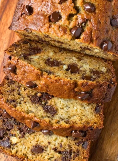 Delicious homemade chocolate chip banana bread on a wooden cutting board