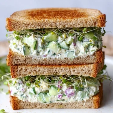 Delicious cucumber salad sandwiches on a plate, garnished and ready to serve.