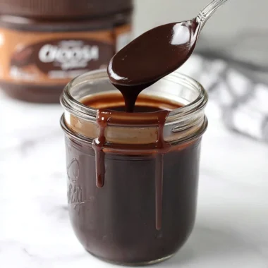 A delicious bowl of hot fudge drizzled over ice cream