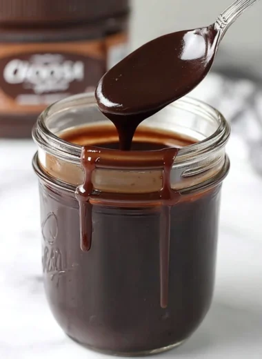 A delicious bowl of hot fudge drizzled over ice cream