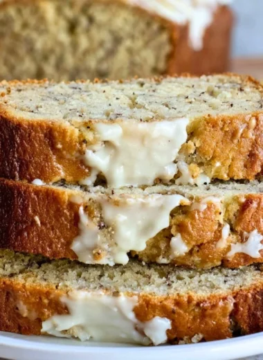 Delicious slice of perfect banana bread on a wooden cutting board
