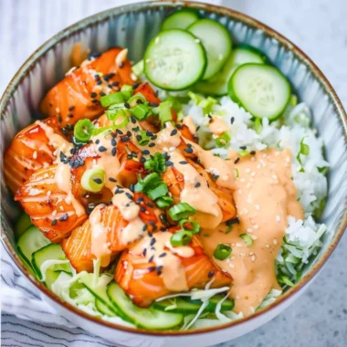 Delicious Spicy Salmon Bowl with fresh vegetables and zesty sauce