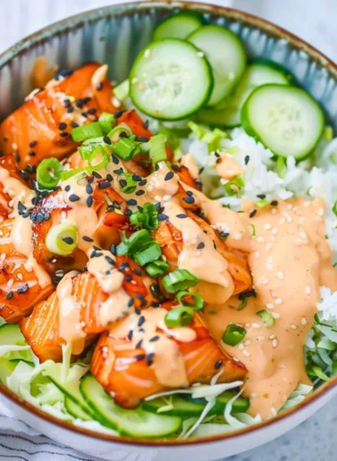 Delicious Spicy Salmon Bowl with fresh vegetables and zesty sauce