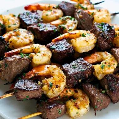 Surf and Turf Kebabs drizzled with Chimichurri Sauce on a platter