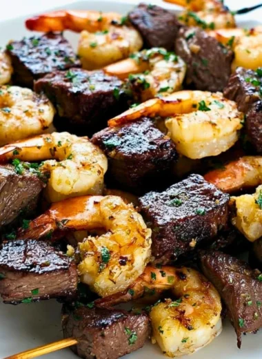 Surf and Turf Kebabs drizzled with Chimichurri Sauce on a platter