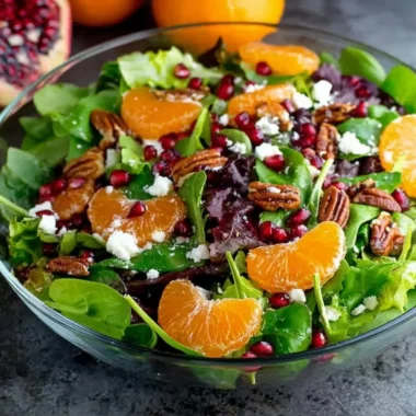 Colorful winter salad with seasonal greens, nuts, and citrus dressing.