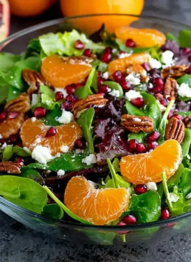 Colorful winter salad with seasonal greens, nuts, and citrus dressing.