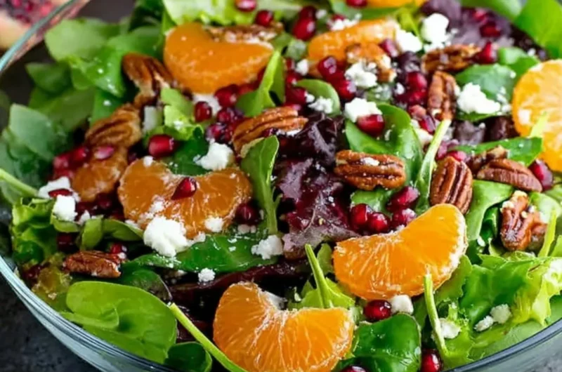 Colorful winter salad with seasonal greens, nuts, and citrus dressing.