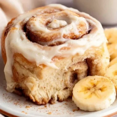Delicious banana bread cinnamon rolls topped with creamy frosting
